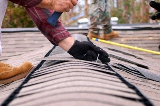 Roofer working on roof